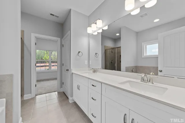 a bathroom with a double vanity sink and a mirror