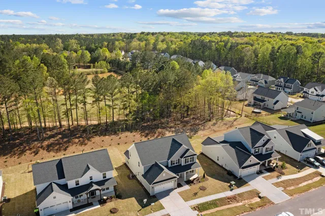 an aerial view of residential houses with outdoor space