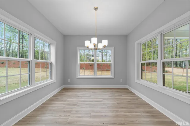 a view of an empty room with windows