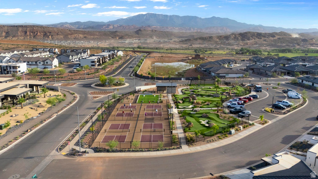 2133 Wolverine Way, Unit 2440 Washington, UT 84780 - Photo 35 of 39 Community amenities featuring multiple pickleball courts, a miniature golf course, and paved parking, surrounded by residential properties and distant mountains