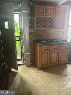 2518 Ellsworth Street Philadelphia, PA 19146 - Photo 4 of 11 a kitchen with granite countertop a sink cabinets and a wooden floor