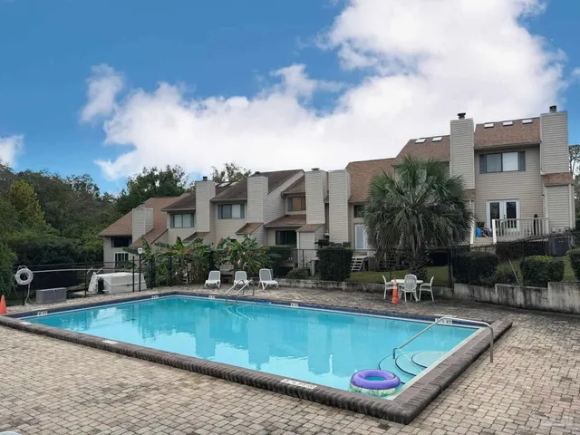 a view of a swimming pool with a lounge chairs