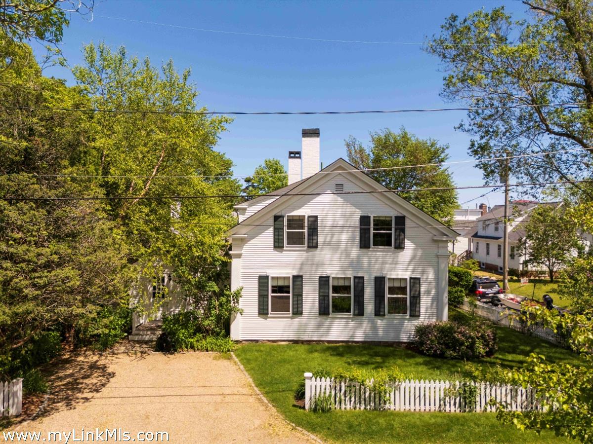 27 Spring Street Vineyard Haven, MA 02568 - Photo 56 of 58 a front view of a house with a garden and plants