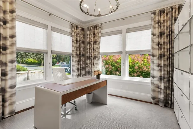 a room with a large window and a chandelier