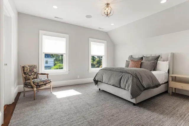 a bedroom with a bed and chair