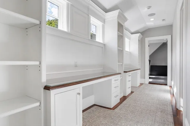 a large white kitchen with granite countertop a sink