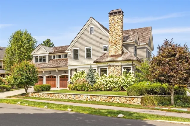 a front view of a house with a garden and plants
