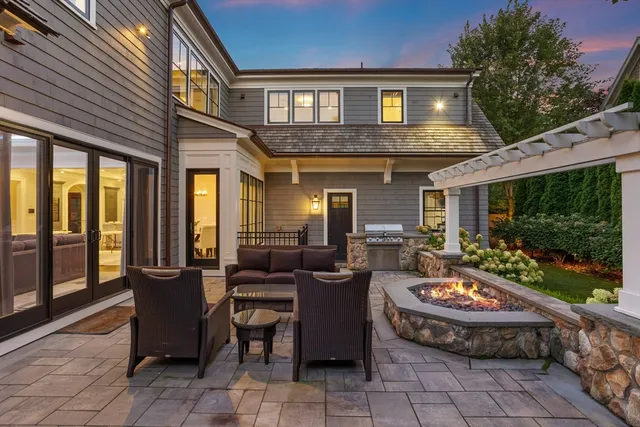 a view of a patio with couches table and chairs and potted plants