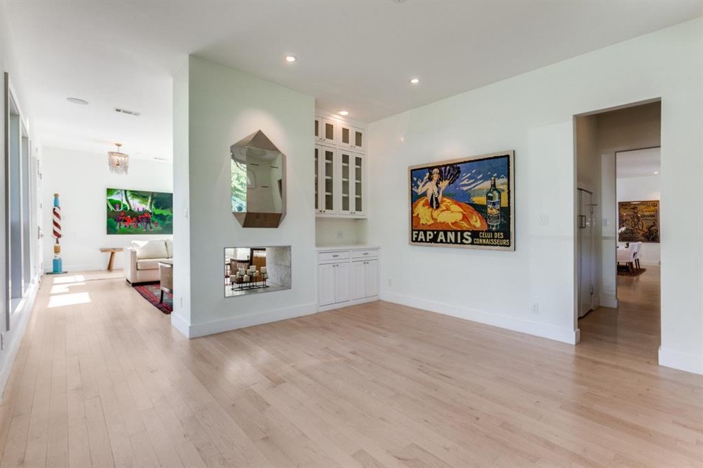 4206 Manning Lane Dallas, TX 75220 - Photo 7 of 35 a view of a hallway with wooden floor and a flat screen tv