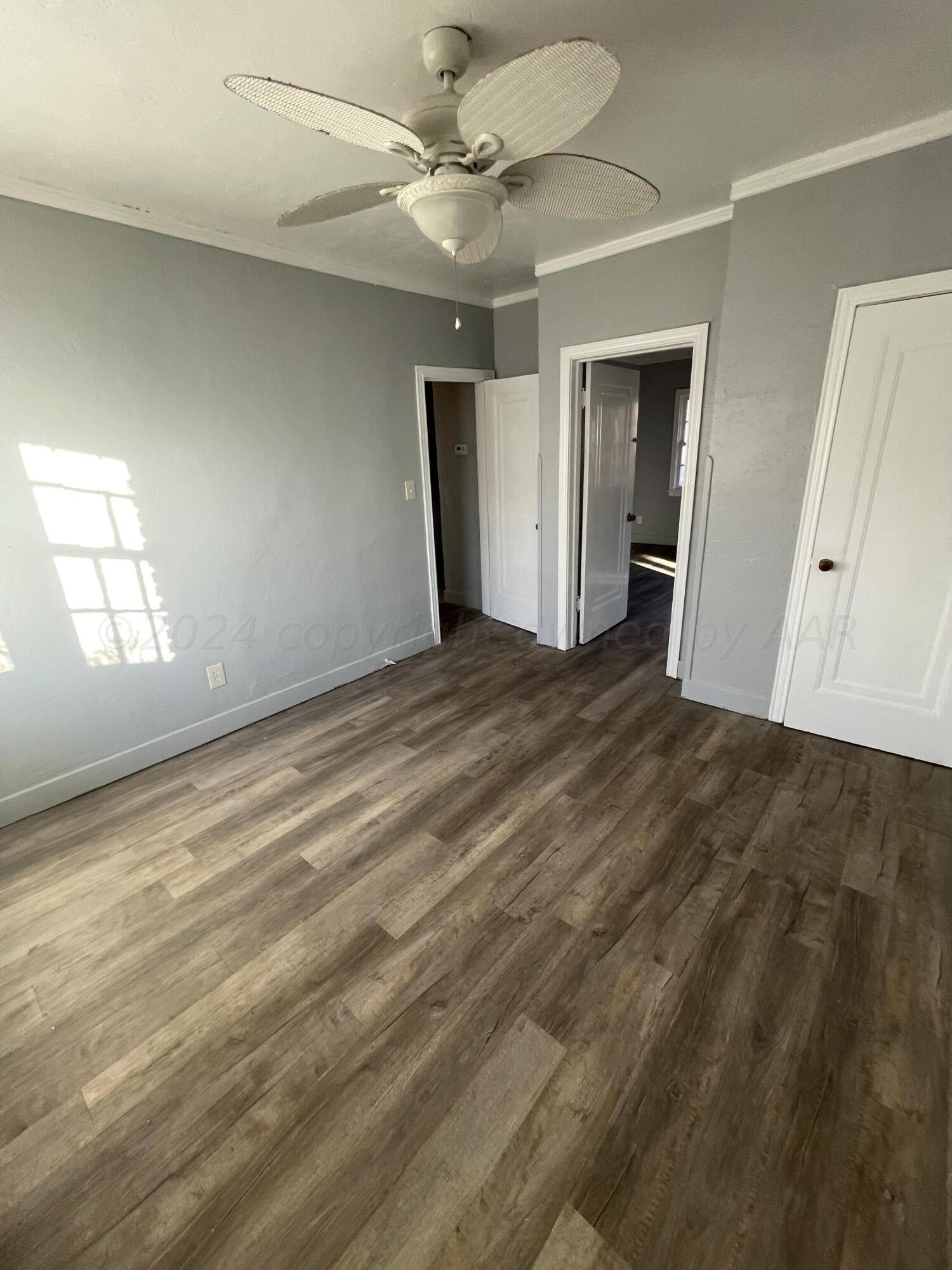 1102 South Western Street Amarillo, TX 79106 - Photo 5 of 9 wooden floor in an empty room with a window
