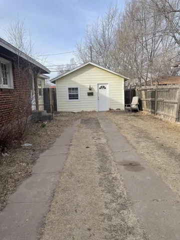 a view of a house with a backyard