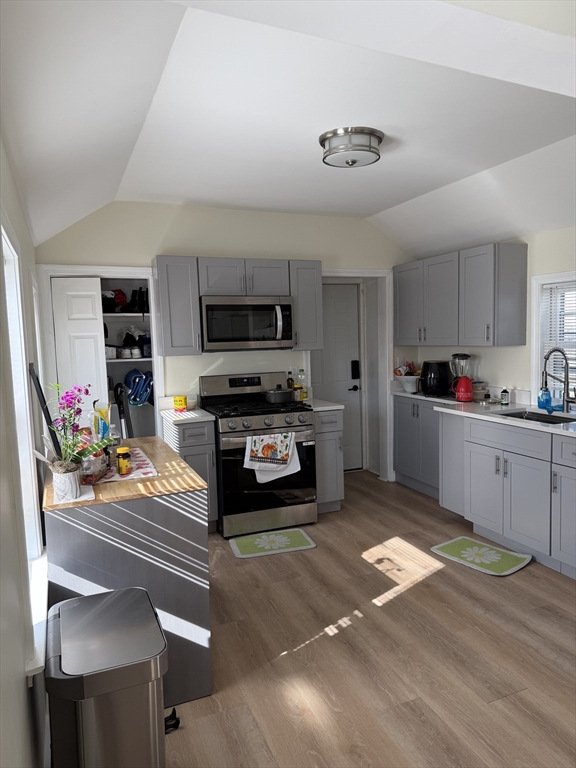 30 Chestnut Street, Unit 1 Framingham, MA 01701 - Photo 1 of 6 a kitchen with stainless steel appliances kitchen island granite countertop a stove and cabinets