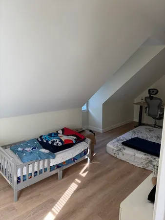 a bedroom with a bed and a dresser