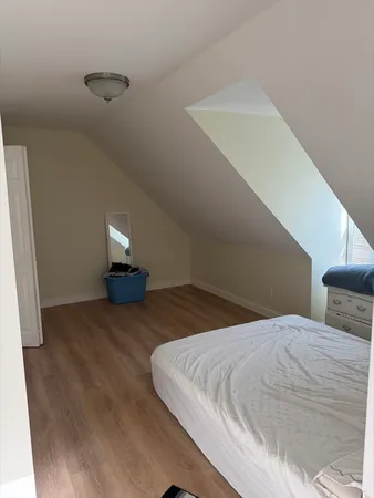 a bedroom with a bed and night stand