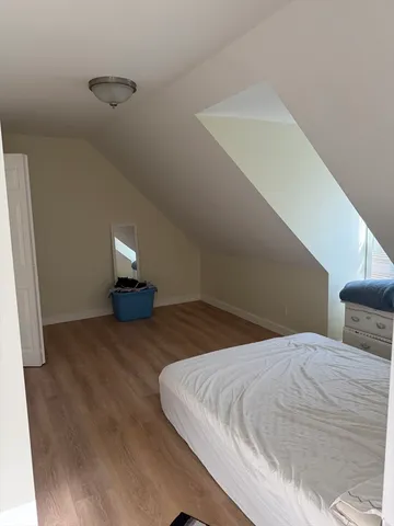 a bedroom with a bed and night stand