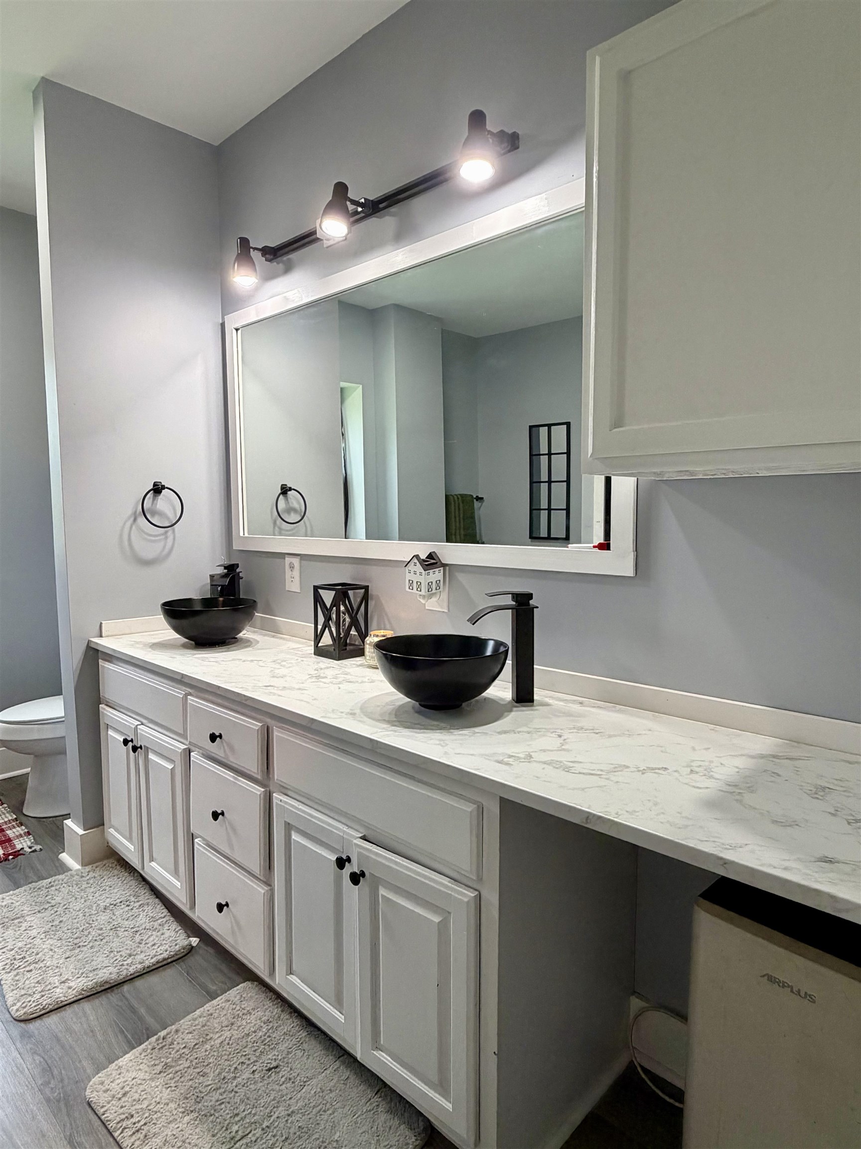 3670 Peavine Road Middleton, TN 38052 - Photo 20 of 36 Dual vessel sinks with matte black fixtures, set into a white countertop with integrated backsplash