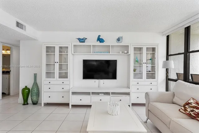 a living room with furniture and large windows