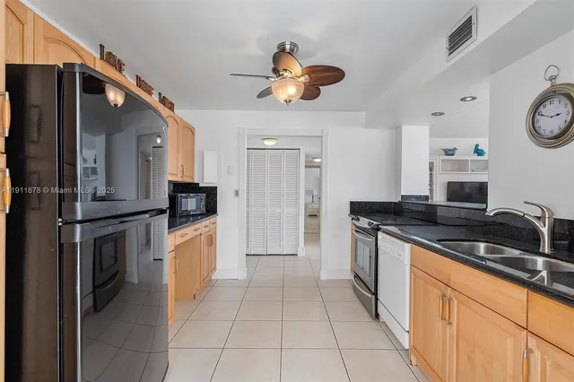 a kitchen with stainless steel appliances a stove a refrigerator and a microwave