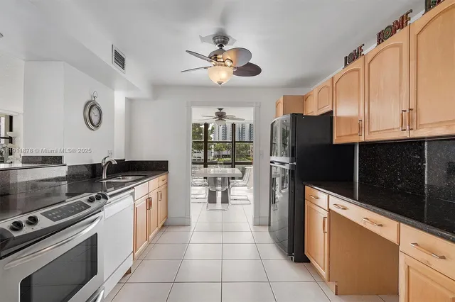a kitchen with refrigerator and window
