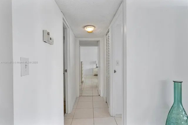 a bedroom with a bed and large window