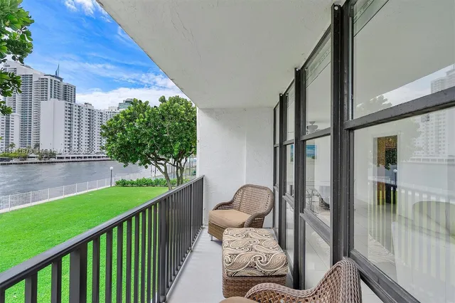 a view of swimming pool with outdoor seating and city view