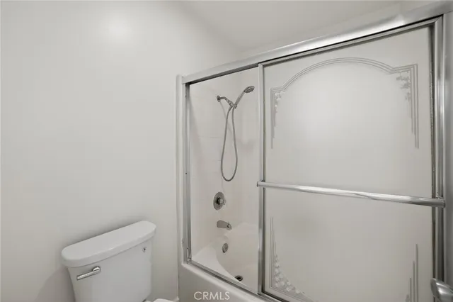a bathroom with a glass shower door