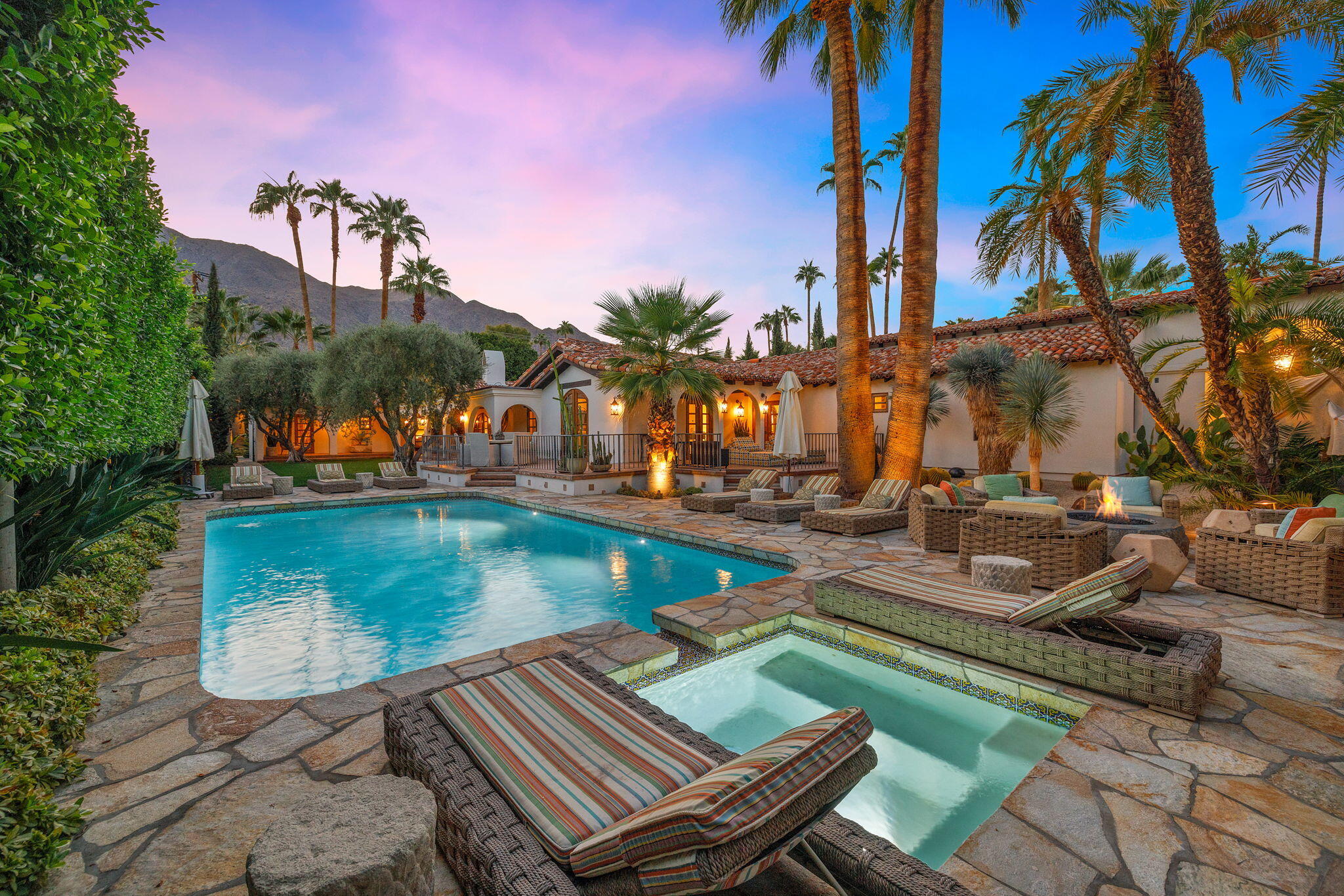 a view of a swimming pool with lounge chairs in patio