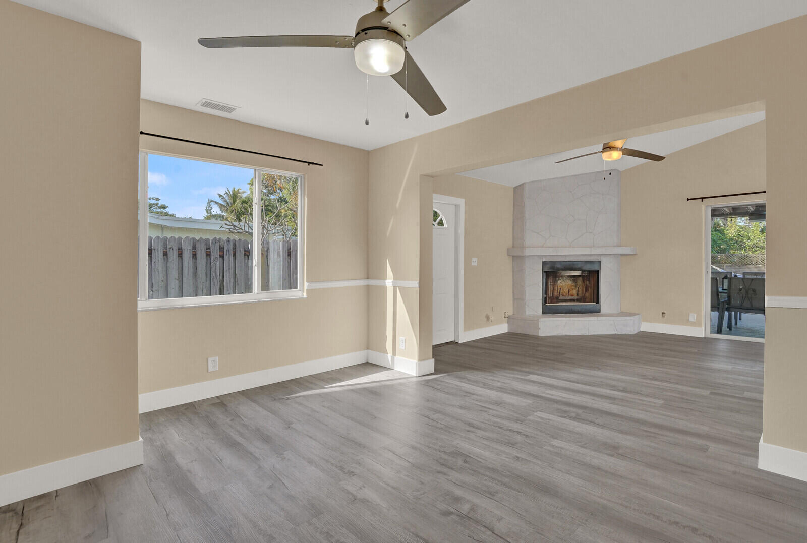 101 Northwest 9th Street Boca Raton, FL 33432 - Photo 13 of 35 an empty room with wooden floor fireplace and windows
