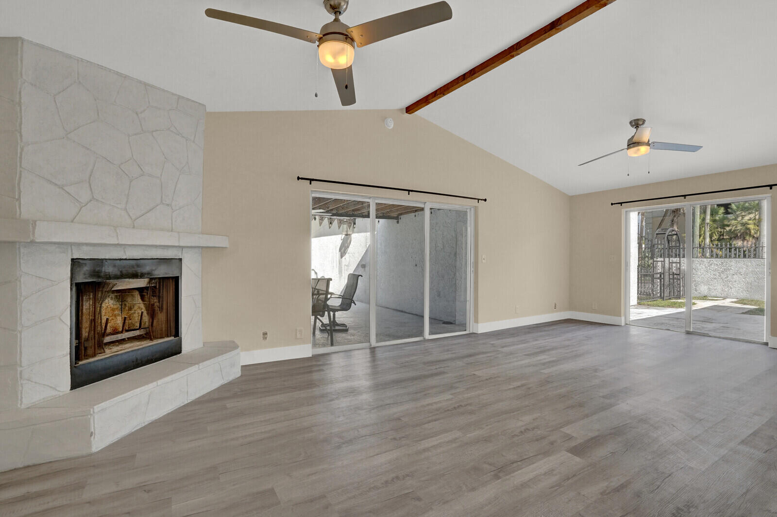 101 Northwest 9th Street Boca Raton, FL 33432 - Photo 16 of 35 an empty room with wooden floor fireplace and windows