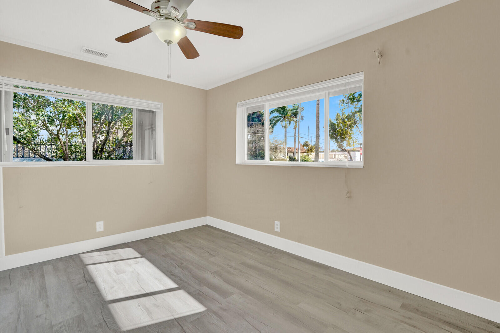 101 Northwest 9th Street Boca Raton, FL 33432 - Photo 20 of 35 a view of an empty room with wooden floor and a window