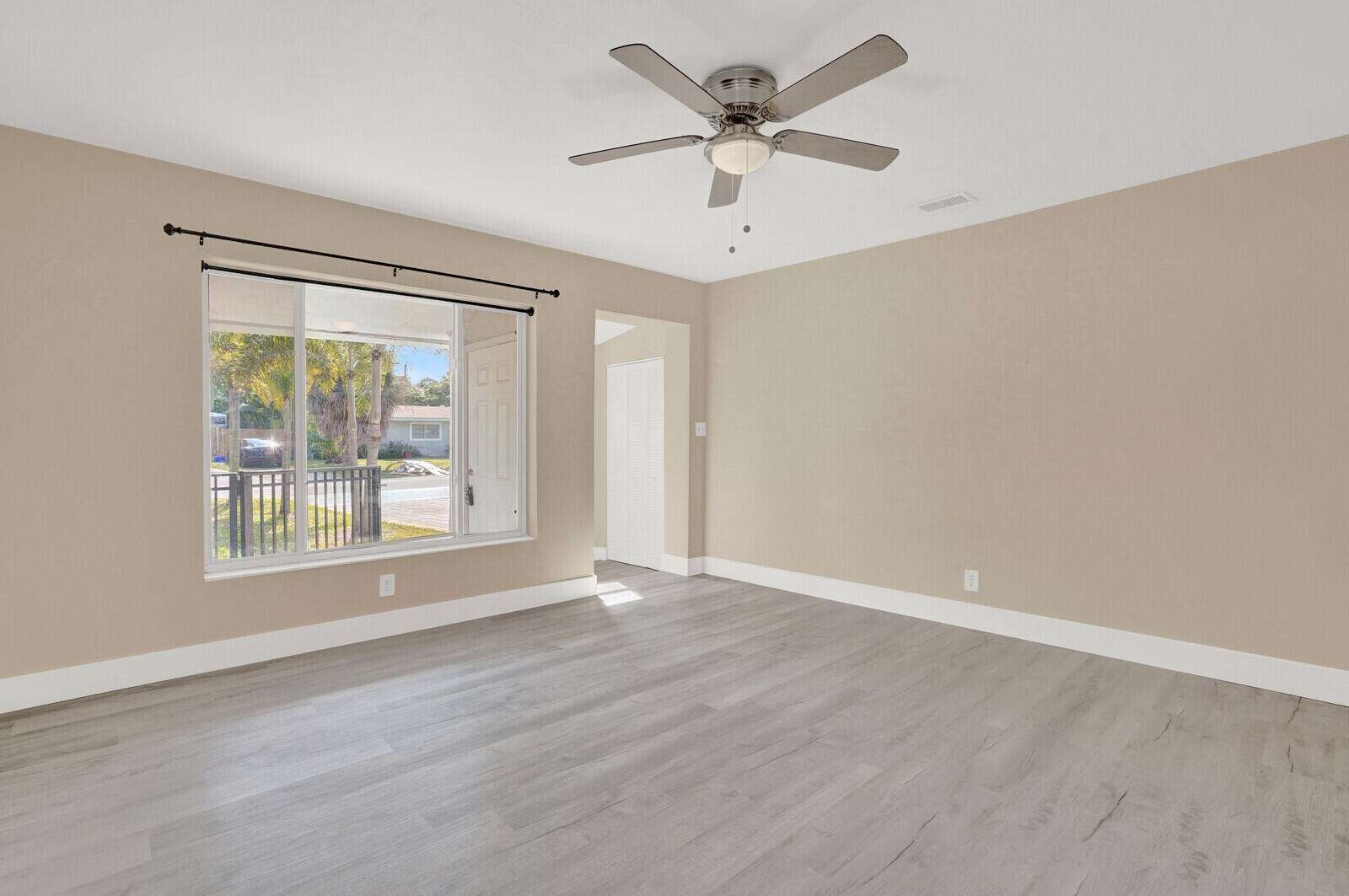 101 Northwest 9th Street Boca Raton, FL 33432 - Photo 5 of 35 an empty room with wooden floor and windows
