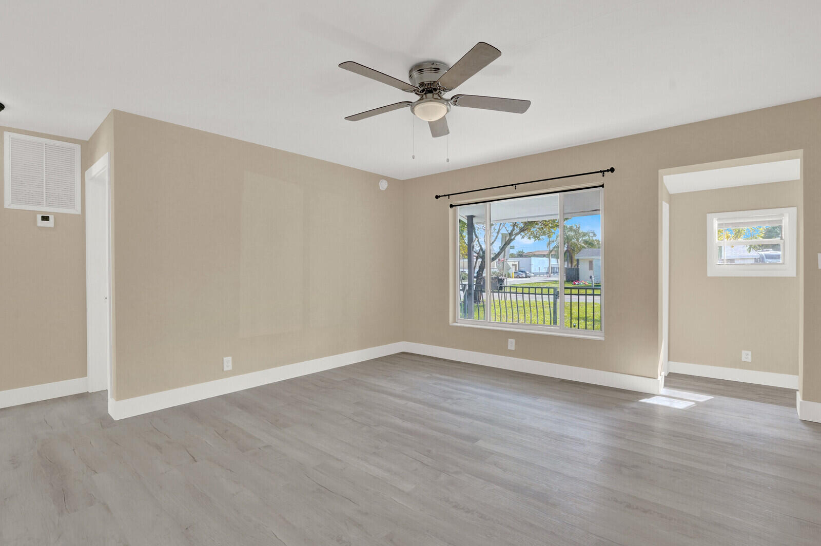 101 Northwest 9th Street Boca Raton, FL 33432 - Photo 6 of 35 a view of an empty room with a window and wooden floor