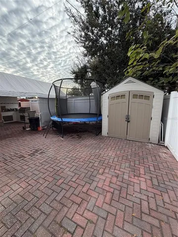 a view of a backyard with a large tree