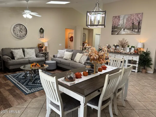 a living room with furniture a clock and wall paintings