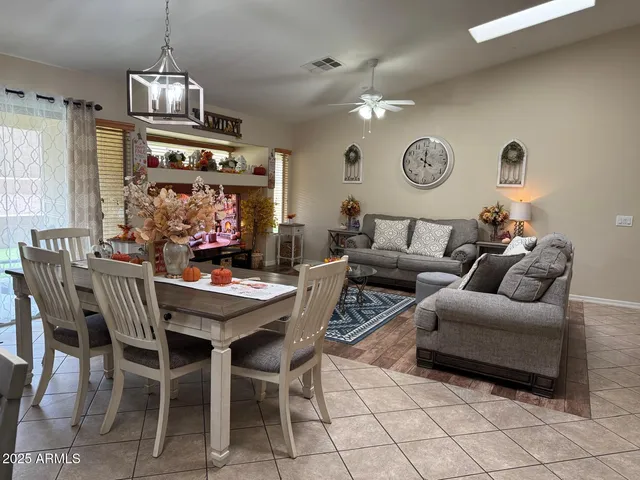 a living room with furniture a chandelier and a window