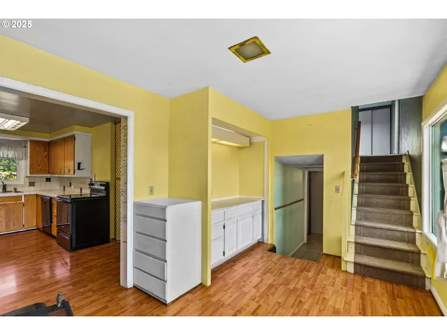 a open kitchen with cabinets and stainless steel appliances