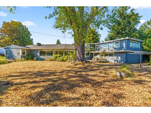 a backyard of a house with table and chairs