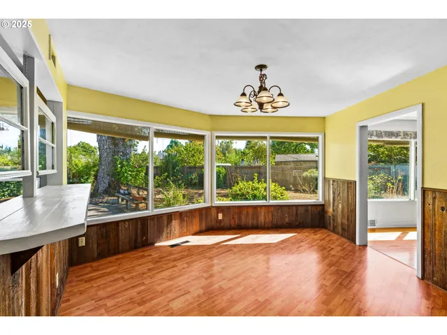 a view of a room with wooden floor and windows