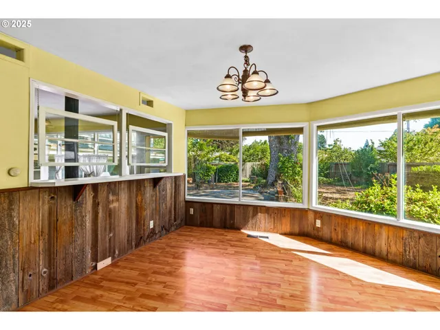 a view of a room with wooden floor and windows