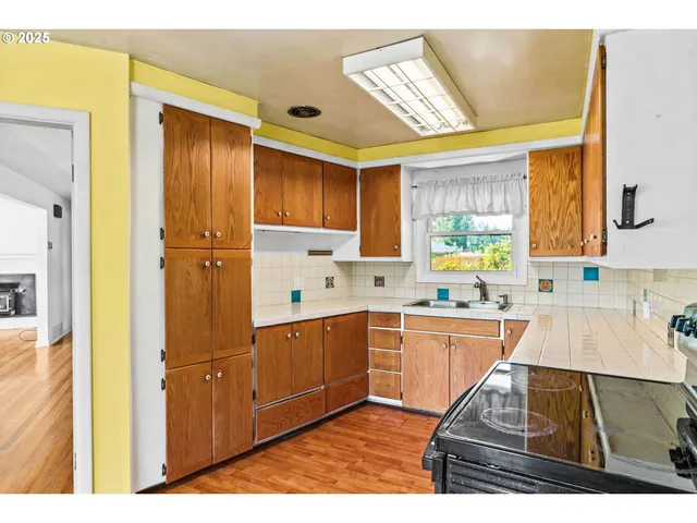 a kitchen with stainless steel appliances granite countertop a sink and cabinets
