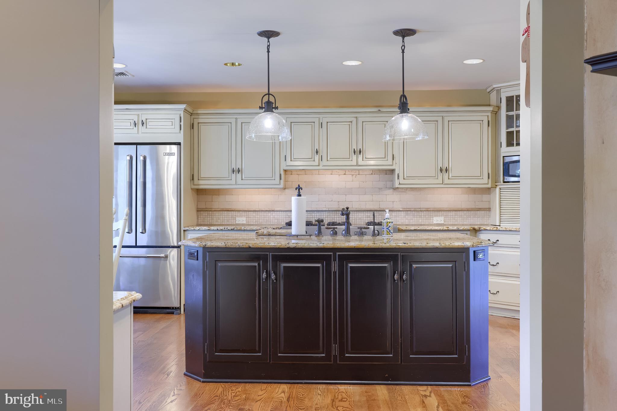 38 Westwind Circle Lititz, PA 17543 - Photo 32 of 113 a kitchen with kitchen island granite countertop stainless steel appliances a sink and a wooden floor