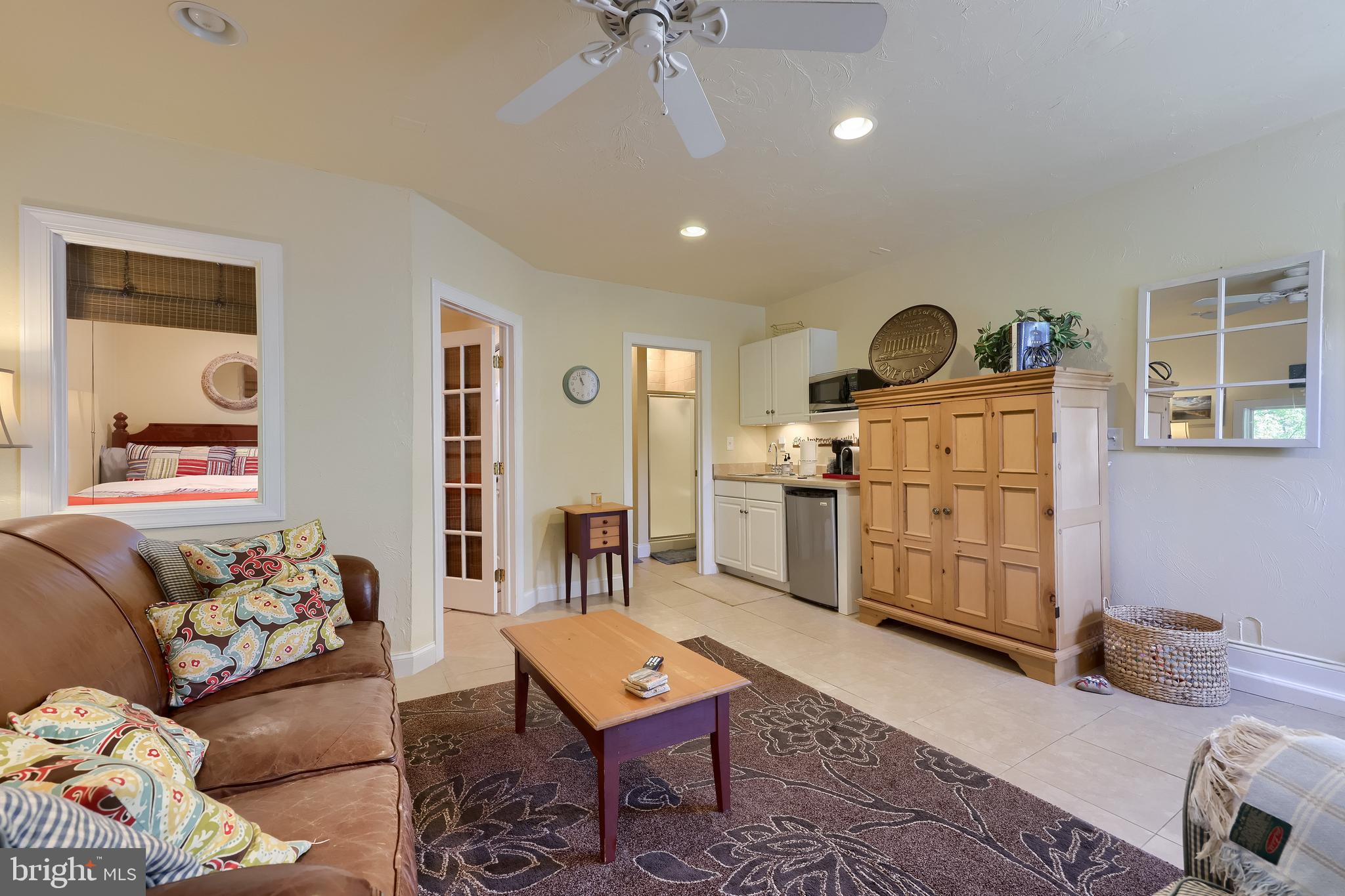 38 Westwind Circle Lititz, PA 17543 - Photo 75 of 113 a living room with furniture a rug kitchen view and a chandelier