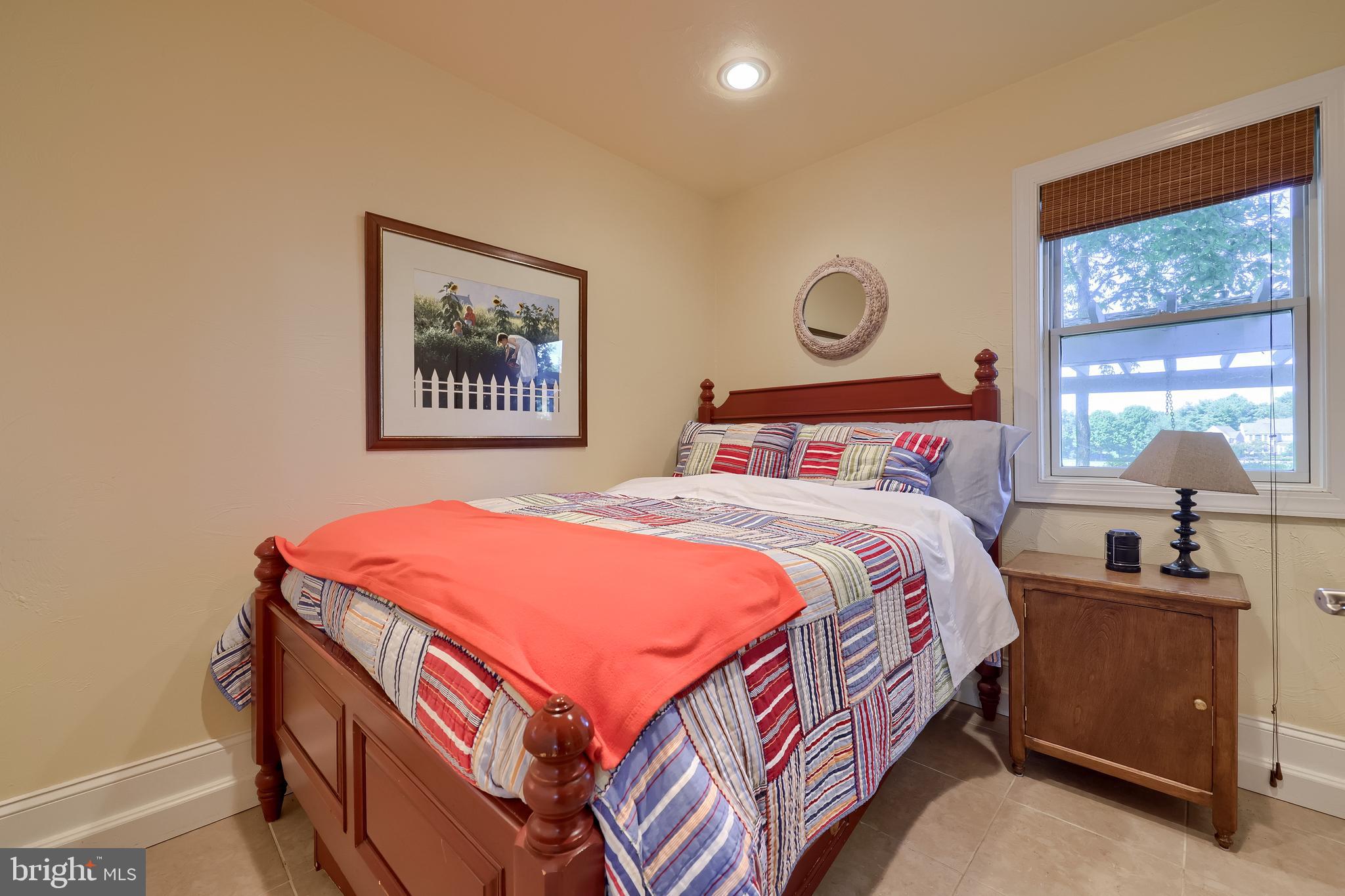 38 Westwind Circle Lititz, PA 17543 - Photo 79 of 113 a bedroom with a bed and a lamp on dresser