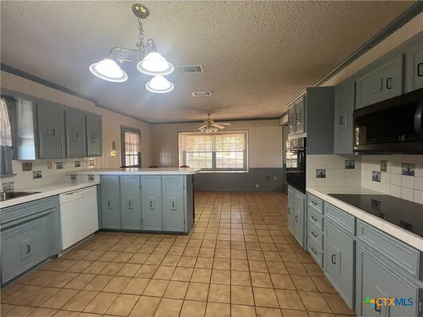 a large kitchen with a large window