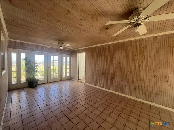 a large kitchen with cabinets chairs and stainless steel appliances