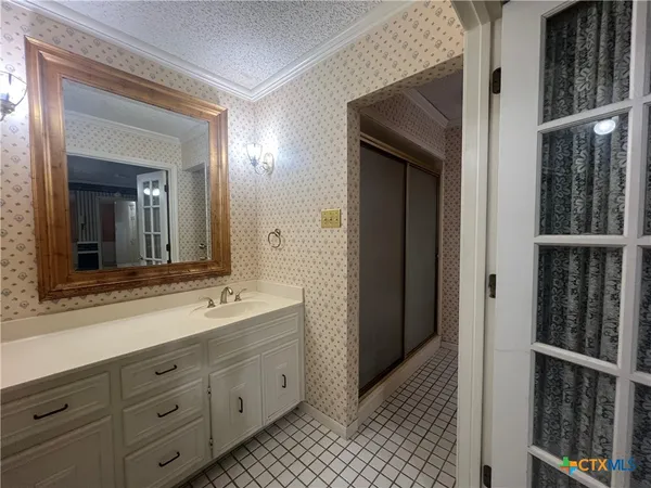 a bathroom with a double vanity sink and a mirror