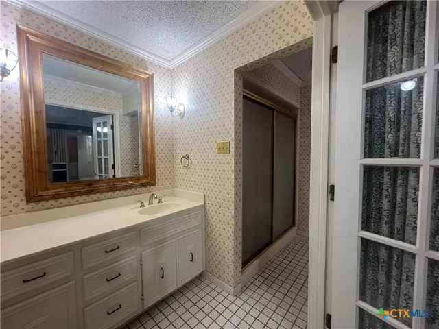 a bathroom with a double vanity sink and a mirror