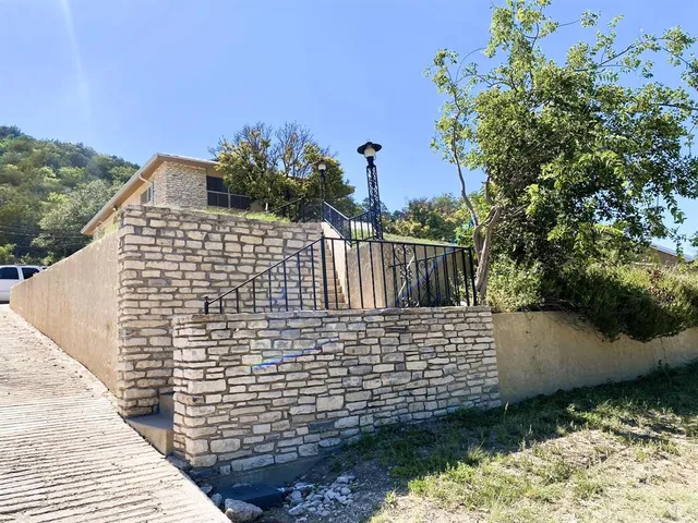 a view of balcony with wooden floor and fence