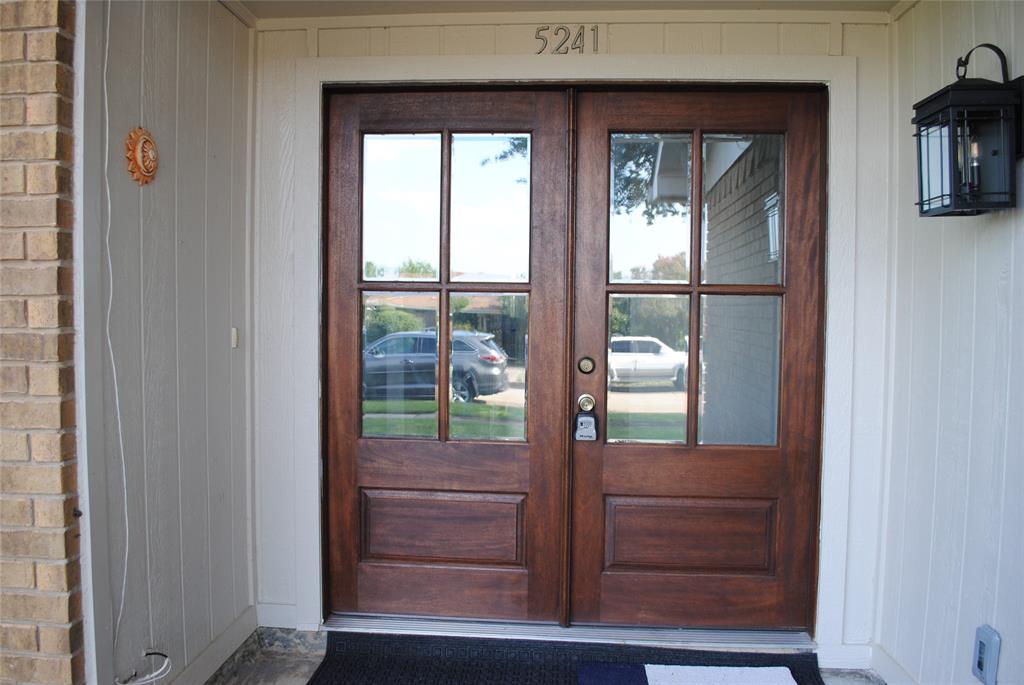 5241 Reed Drive The Colony, TX 75056 - Photo 3 of 26 Double entry doors featuring a rich wood finish and glass panels