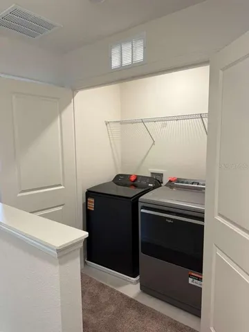 a bathroom with a stove and a refrigerator